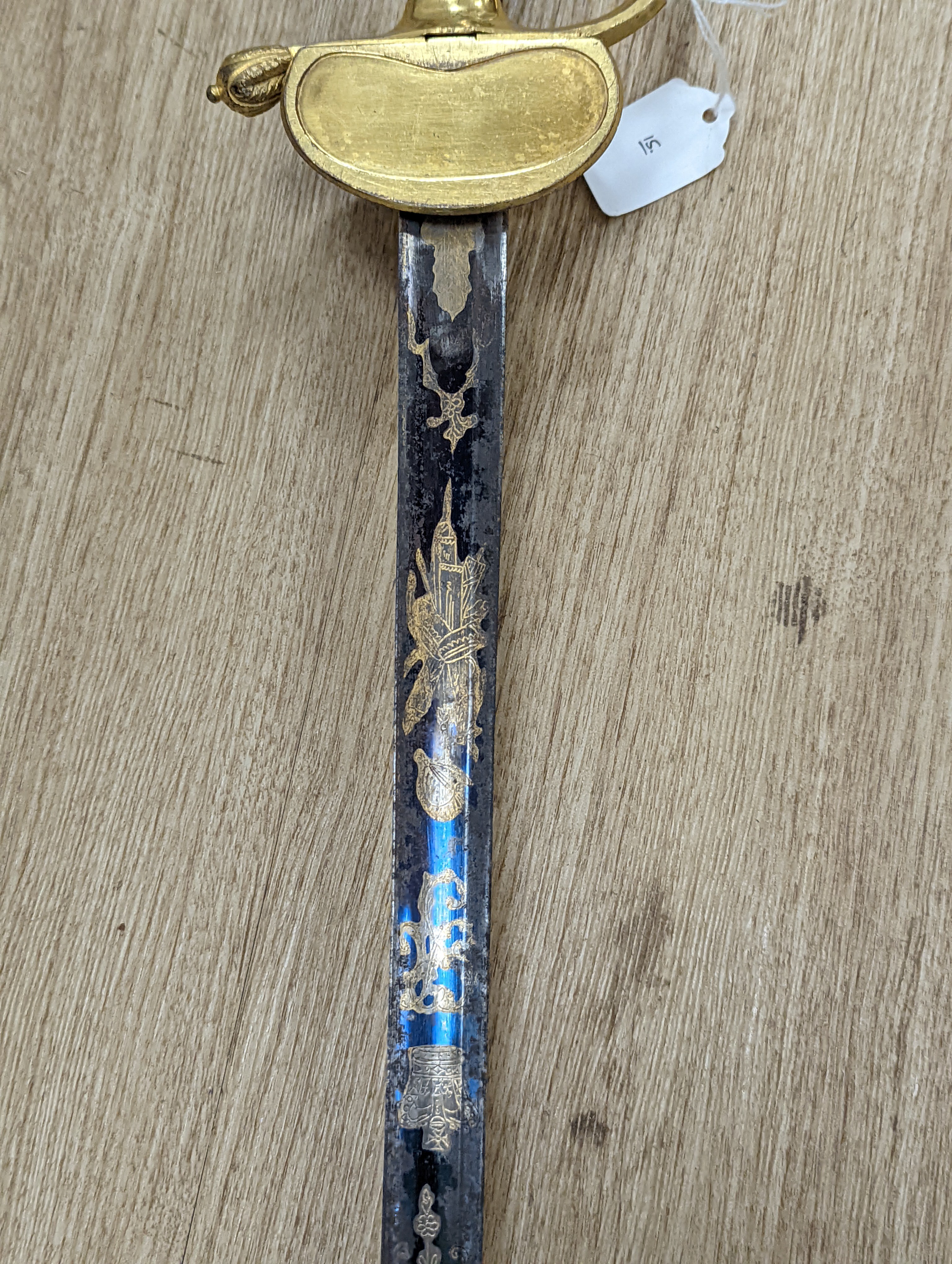 A fine Georgian officer’s sword, blade etched blued and gilt with crowned GR, royal arms and trophy of arms, gilt handle with folding side guard, silver wire bound grip, blade 81cms.